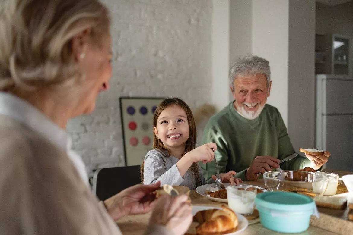 Little girl having breakfast with grandparents Little girl having breakfast with grandparents
