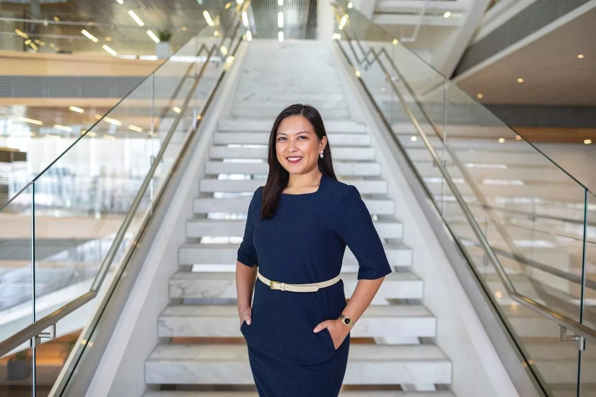 Woman posing by the stairs