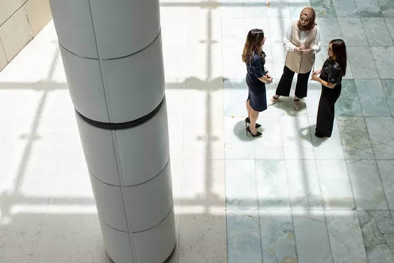 Three women of different nationalities are discussing Three women of different nationalities are discussing